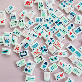 White Mahjong tile set from the House Collection, featuring intricately designed tiles with floral motifs, butterflies, and peacocks. Tile size: 1" x 1 7/16" x 7/16".
