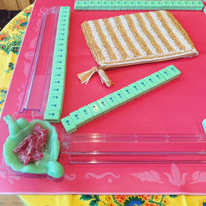 Green mahjong tiles on a pink Mahjong mat with light pink seashell and ocean-inspired border