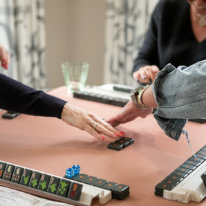 Mahjong lessons in progress with players playing tiles