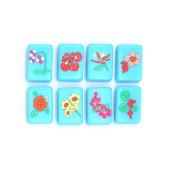 Bright blue Mahjong tiles from island collection featuring flowers. Tile size: 1" x 1 7/16" x 7/16". 