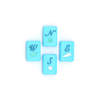 Bright blue Mahjong tiles from island collection featuring winds. Tile size: 1" x 1 7/16" x 7/16". 