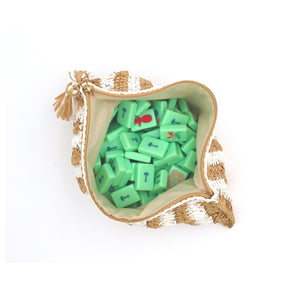 White and tan striped raffia Mahjong bag with green Mahjong tiles inside