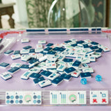 Navy Mahjong tile set from the House Collection, featuring intricately designed tiles with floral motifs, butterflies, and peacocks. Tile size: 1" x 1 7/16" x 7/16". 