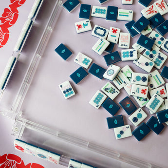 Navy Mahjong tile set from the House Collection, featuring intricately designed tiles with floral motifs, butterflies, and peacocks. Tile size: 1" x 1 7/16" x 7/16". 