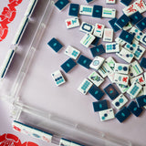 Navy Mahjong tile set from the House Collection, featuring intricately designed tiles with floral motifs, butterflies, and peacocks. Tile size: 1" x 1 7/16" x 7/16". 