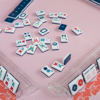 Navy Mahjong tile set from the House Collection, featuring intricately designed tiles with floral motifs, butterflies, and peacocks. Tile size: 1" x 1 7/16" x 7/16". 