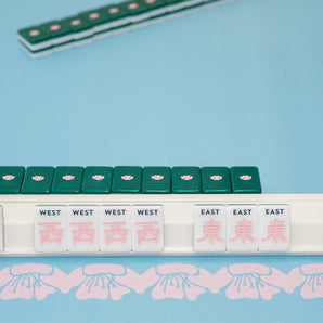 Green Mahjong tile set from the House Collection, featuring intricately designed tiles with floral motifs, butterflies, and peacocks. Tile size: 1" x 1 7/16" x 7/16". 