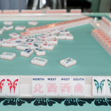 Pink Mahjong tile set from the House Collection, featuring intricately designed tiles with floral motifs, butterflies, and peacocks. Tile size: 1" x 1 7/16" x 7/16". 