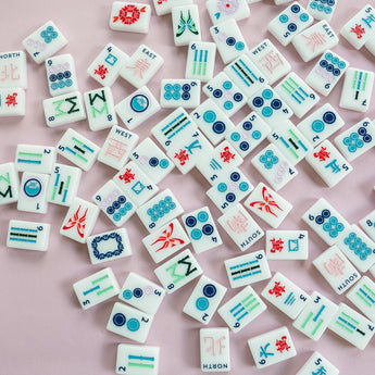 White Mahjong tile set from the House Collection, featuring intricately designed tiles with floral motifs, butterflies, and peacocks. Tile size: 1" x 1 7/16" x 7/16". 
