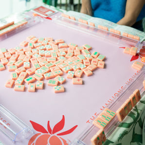 Coral Mahjong mat with blue peony corner details and “The Mahjong House” logo