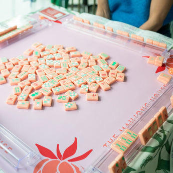 Coral Mahjong mat with blue peony corner details and “The Mahjong House” logo
