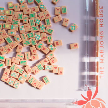 Coral Mahjong mat with blue peony corner details and “The Mahjong House” logo