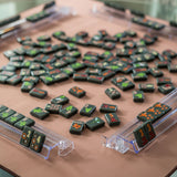 Dark Mahjong tiles on a brown Mahjong mat with orange stars in two corners