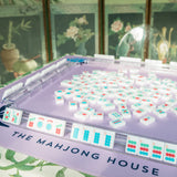 Lavender Mahjong mat with blue peony corner details and “The Mahjong House” logo