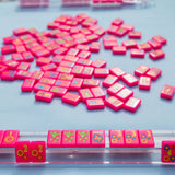 Hot pink Texas-themed Mahjong tiles featuring Western-inspired designs like cowboy boots, wildflowers, and BBQ motifs for playful and bold game night vibes